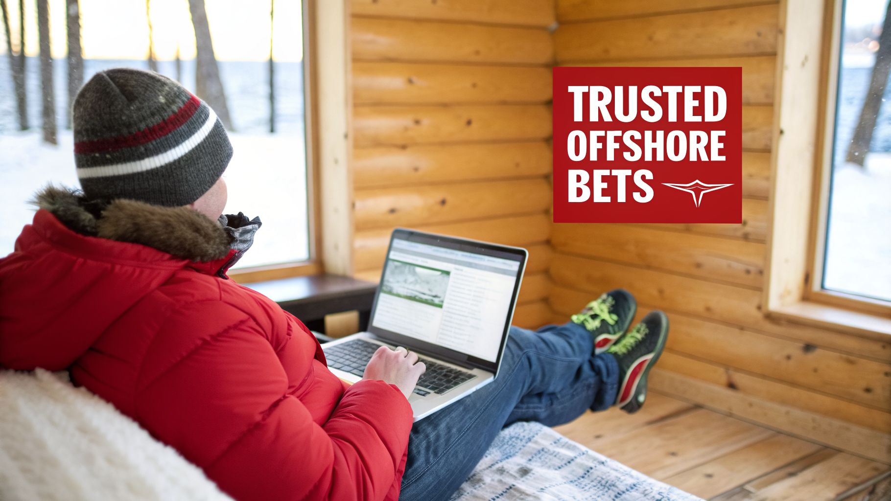 A person in a red jacket and beanie uses a laptop indoors with a snowy view and "TRUSTED OFFSHORE BETS" text.