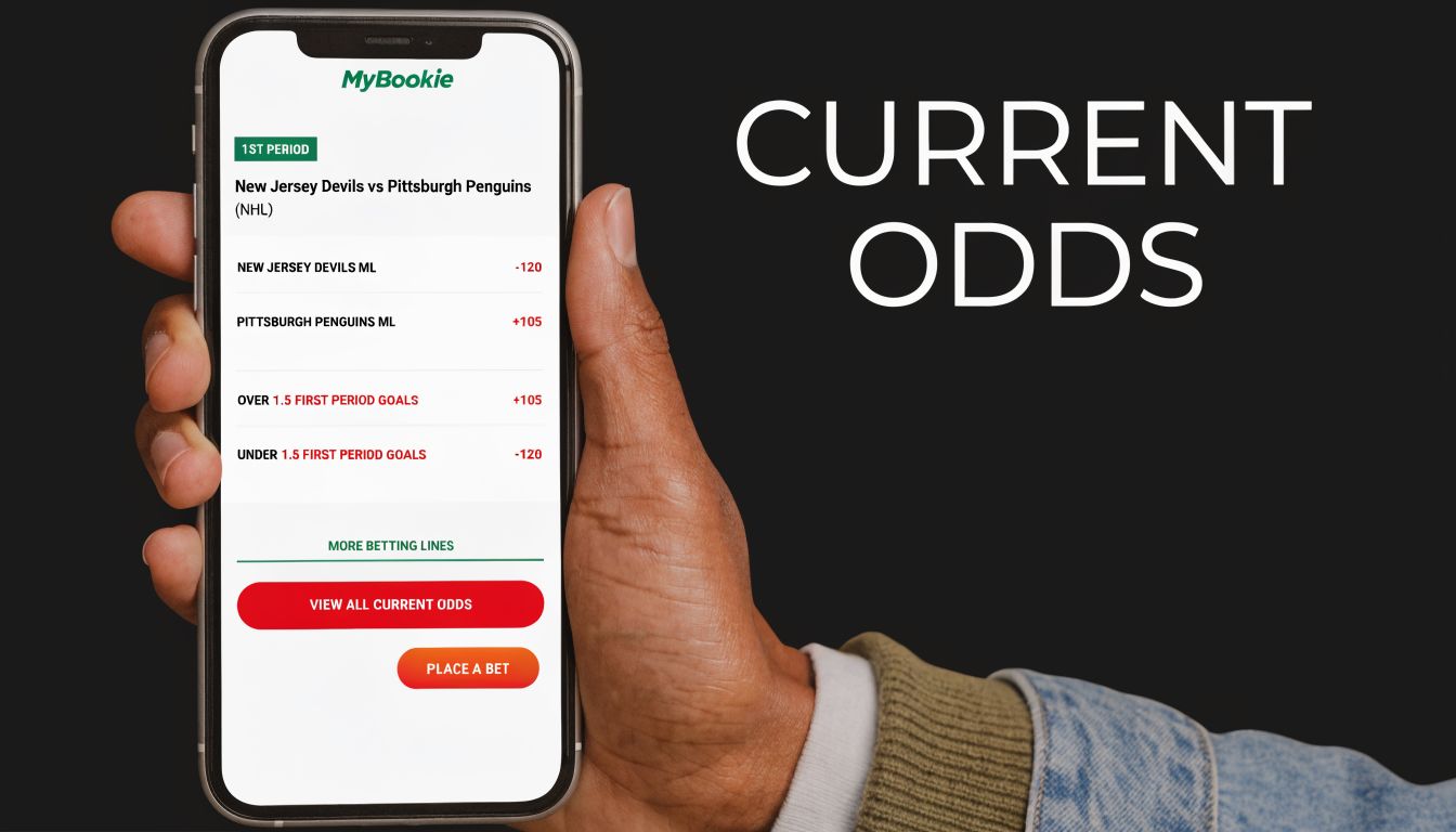 A hand holding a smartphone showing MyBookie NHL betting odds for the New Jersey Devils versus Pittsburgh Penguins game.