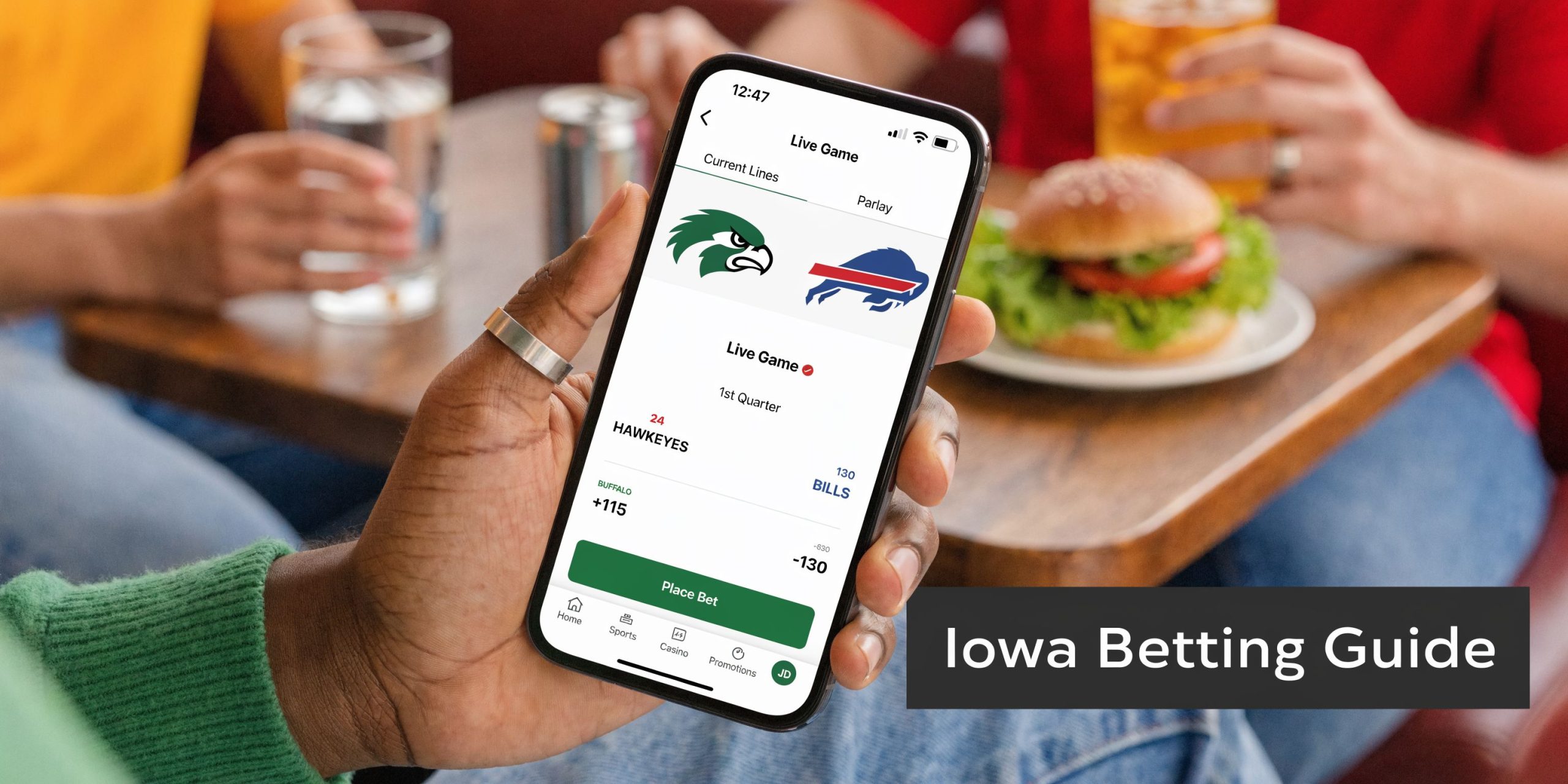 Best Iowa Sports Betting Sites & Bonuses 2026 1 A person holding a smartphone displaying an online sports betting application during a meal at a restaurant.