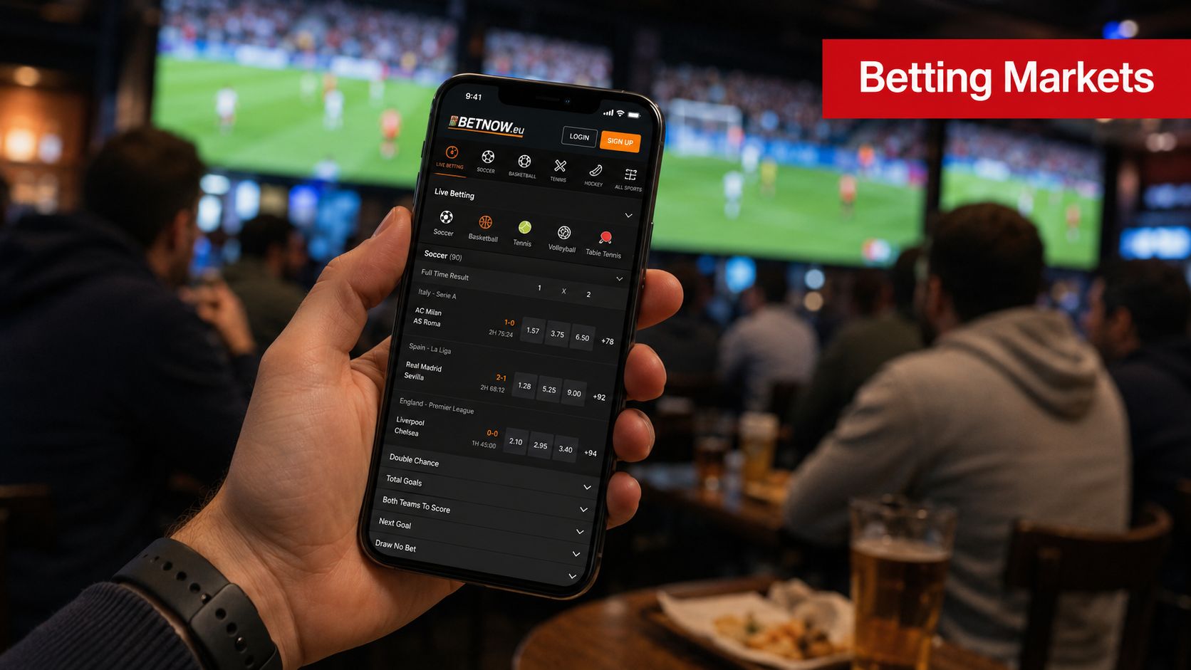 BetNow EU Review 2026: Legit & Safe for US Players? 4 A person holding a smartphone showing the BetNow mobile betting application in a crowded sports bar setting.